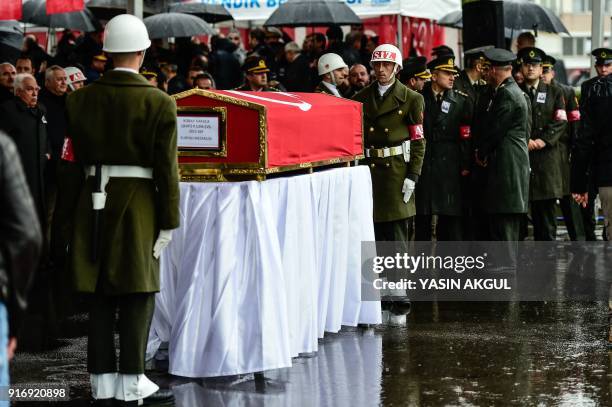 Turkish soldiers stand at attention by the coffin of Koray Karaca, a Turkish soldier who was killed in cross-border clashes with Kurdish People's...