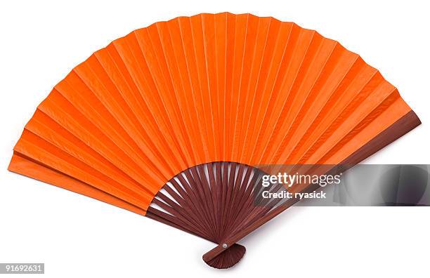 opened orange asian fan with brown stained wood isolated - hand fan stock pictures, royalty-free photos & images