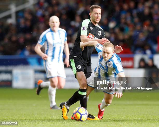 Huddersfield Town's Alex Pritchard battles for the ball during the Premier League match at the John Smith's Stadium, Huddersfield.