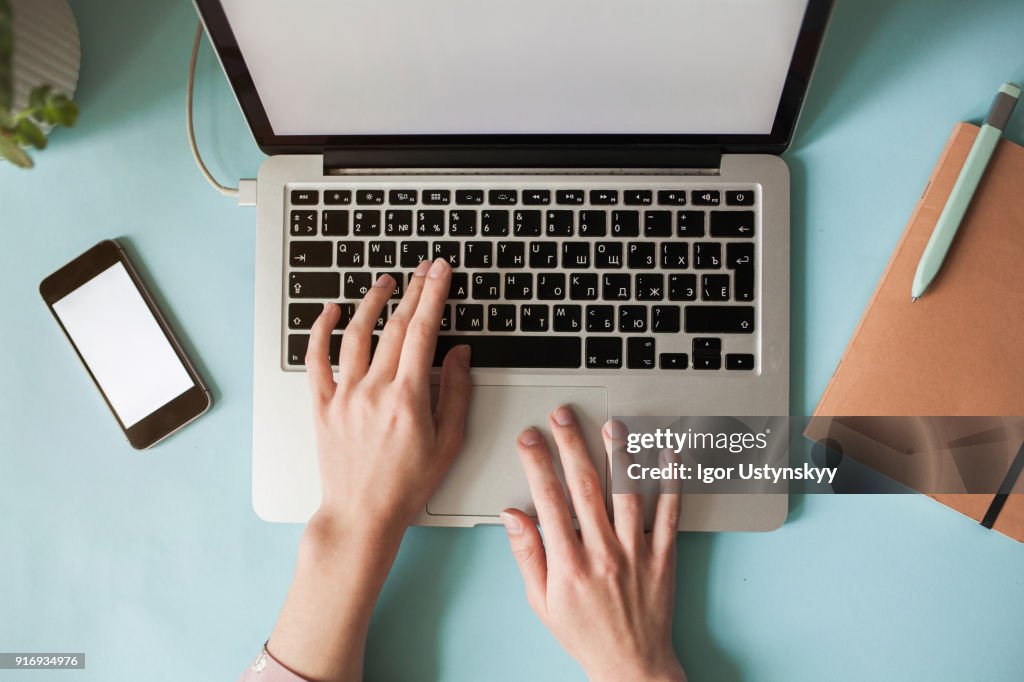High view of caucasian woman using laptop at table