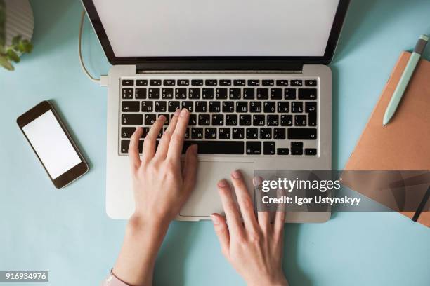 high view of caucasian woman using laptop at table - hand raised bildbanksfoton och bilder