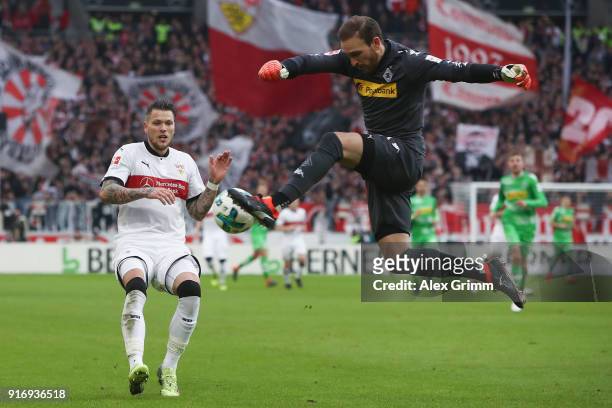 Goalkeeper Tobias Sippel of Moenchengladbach clears the ball ahead of Daniel Ginczek of Stuttgart during the Bundesliga match between VfB Stuttgart...