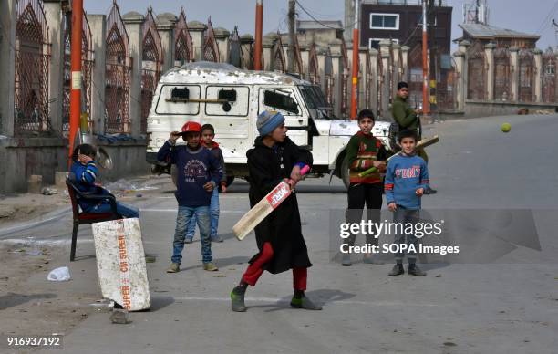 Kashmiri children play cricket during restrictions in old city of Srinagar, Indian administered Kashmir. Curfew-like restrictions have been imposed...