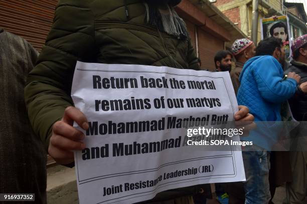 Kashmiri protester holds a placard during protests in Srinagar, Indian administered Kashmir. Curfew-like restrictions have been imposed in parts of...