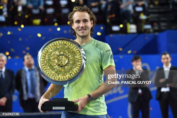 France's tennis player Lucas Pouille poses with his trophy after winning the final of the ATP World Tour Open Sud de France in Montpellier, southern...