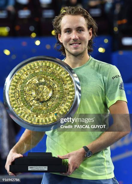 France's tennis player Lucas Pouille poses with his trophy after winning the final of the ATP World Tour Open Sud de France in Montpellier, southern...