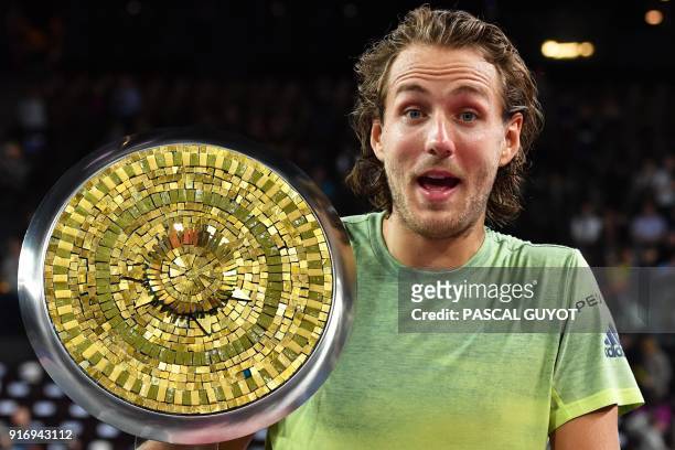 France's tennis player Lucas Pouille poses with his trophy after winning the final of the ATP World Tour Open Sud de France in Montpellier, southern...