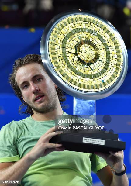 France's tennis player Lucas Pouille poses with his trophy after winning the final of the ATP World Tour Open Sud de France in Montpellier, southern...