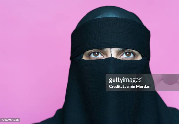 muslim woman with traditional black veil - muslim woman darkness stock pictures, royalty-free photos & images