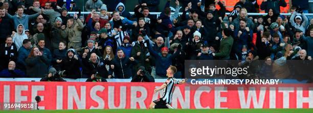 Newcastle United's Scottish midfielder Matt Ritchie celebrates with the crowd after scoring the opening goal during the English Premier League...