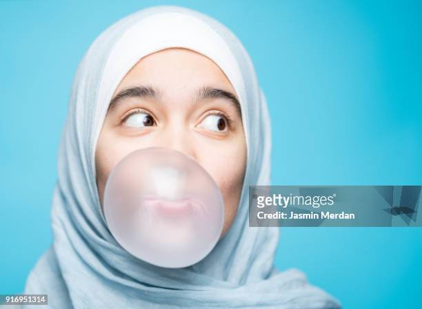 portrait of happy muslim girl with chewing gum - funny muslim stock pictures, royalty-free photos & images