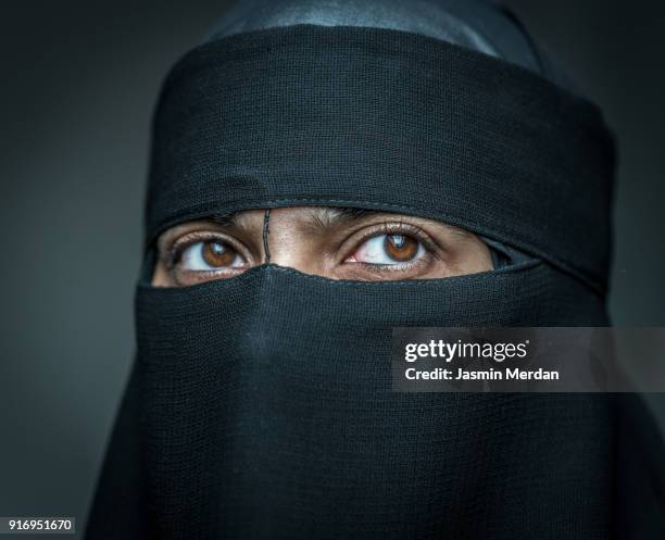 muslim woman with traditional black veil - nikab stock pictures, royalty-free photos & images