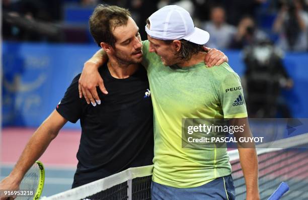 France's tennis players Lucas Pouille and Richard Gasquet embrace after Pouille defeated Gasquet in the final of the ATP World Tour Open Sud de...