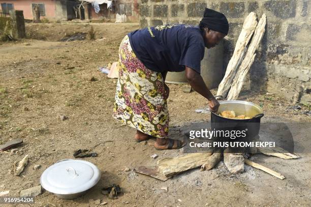 Cameroonian refugee cooks with firewood for her family at temporary home in Agborkim town, Etung district of Cross Rivers State, southeast Nigeria,...