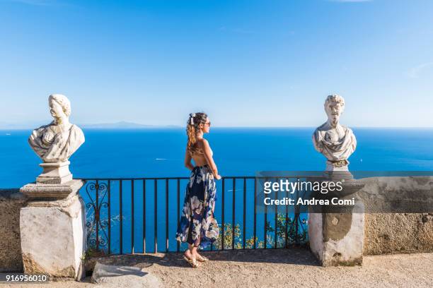 woman admiring the view from terrace of infinity. villa cimbrone, ravello, amalfi coast, salerno, campania, italy - ravello stock-fotos und bilder