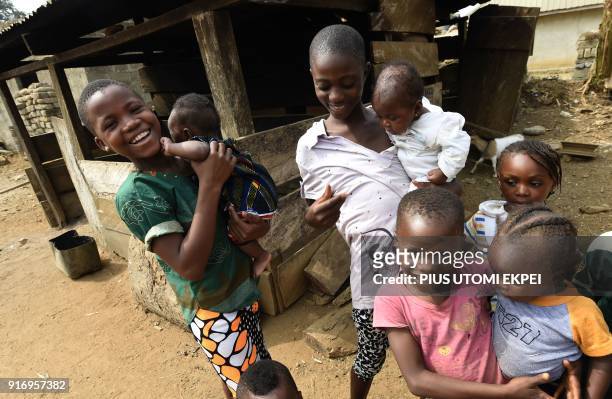 Young Cameroonian refugees carry children in Agborkim town, Etung district of Cross Rivers State, southeast Nigeria, on February 2, 2018. Nigeria on...