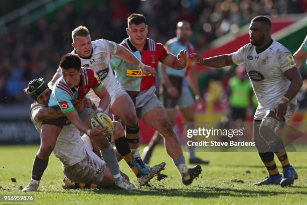 Marcus Smith of Harlequins is tackled by James Gaskell of Wasps during the Aviva Premiership match between Harlequins and Wasps at Twickenham Stoop...