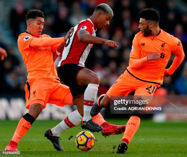 Southampton's Gabonese midfielder Mario Lemina is challenged by Liverpool's Brazilian midfielder Roberto Firmino and Liverpool's English midfielder...