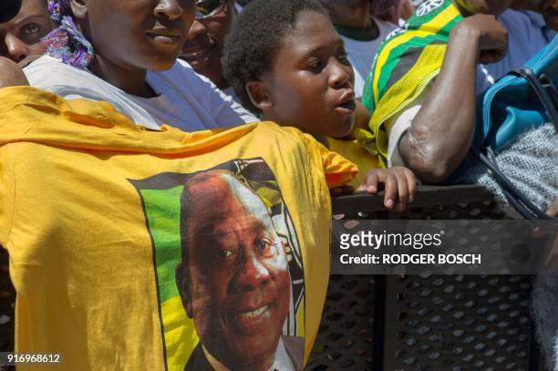 Supporter of South Africa's ruling African National Congress holds up a shirt featuring newly-elected ANC president and South African Deputy...