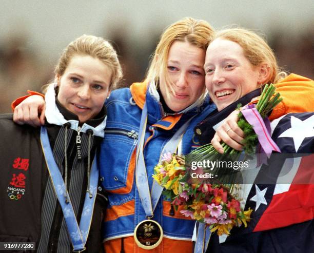 Gunda Niemann-Stirnemann of Germany , Marianne Timmer of the Netherlands and Christine Witty of the USA smile after being awarded their medals for...