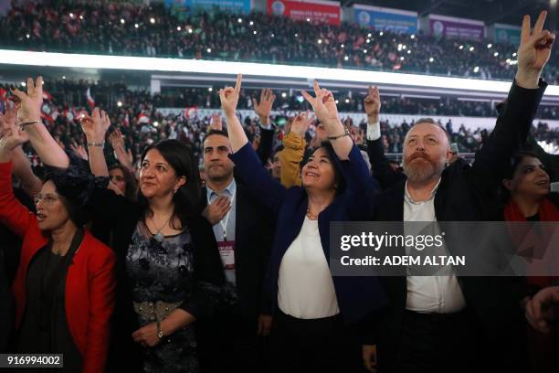 New co-chairs of the pro-Kurdish Peoples' Democratic Party Pervin Buldan and Sezai Temelli and outgoing co-chair Serpil Kemalbay gesture the V-sign...