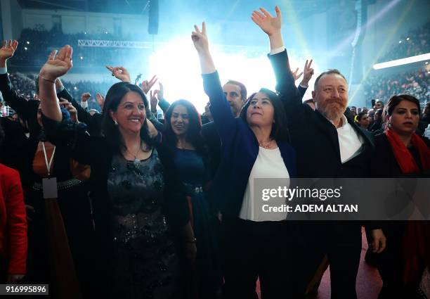 New co-chairs of the pro-Kurdish Peoples' Democratic Party Pervin Buldan and Sezai Temelli and outgoing co-chair Serpil Kemalbay gesture the V-sign...