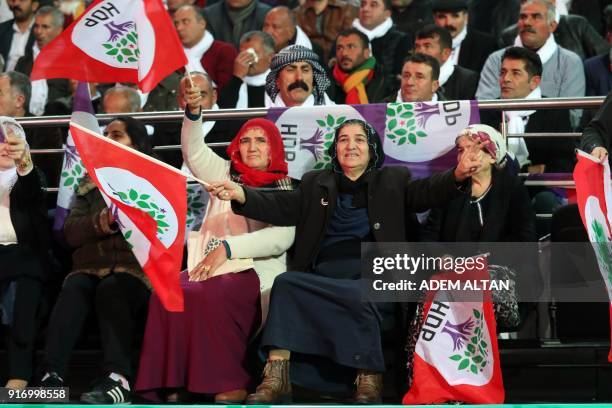 Supporters of the pro-Kurdish Peoples' Democratic Party wave party flags as they attend the HDP congress in Ankara on February 11, 2018. Turkey's...