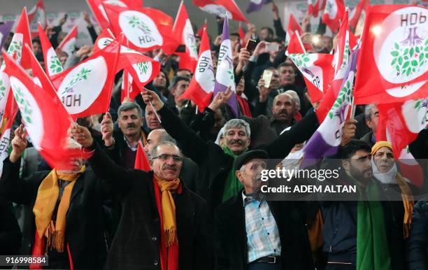 Supporters of the pro-Kurdish Peoples' Democratic Party wave party flags as they attend the HDP congress in Ankara on February 11, 2018. Turkey's...
