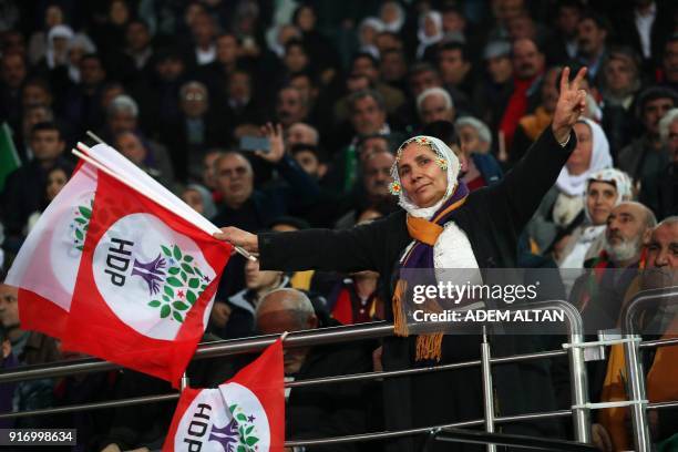 Supporter of the pro-Kurdish Peoples' Democratic Party waves party flags as she attends the HDP congress in Ankara on February 11, 2018. Turkey's...