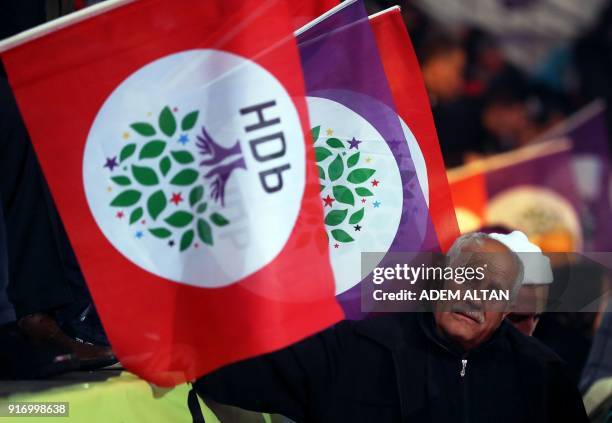 Supporter of the pro-Kurdish Peoples' Democratic Party waves party flags as he attends the HDP congress in Ankara on February 11, 2018. Turkey's main...