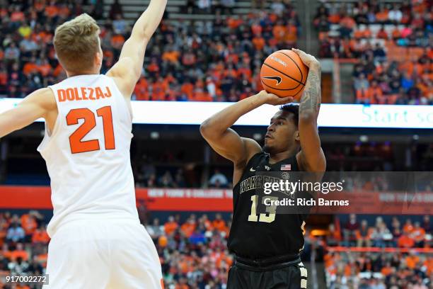 Bryant Crawford of the Wake Forest Demon Deacons shoots the ball against the defense of Marek Dolezaj of the Syracuse Orange during the first half at...
