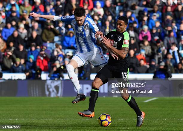 Scott Malone of Huddersfield Town is challenged by Callum Wilson of AFC Bournemouth during the Premier League match between Huddersfield Town and AFC...