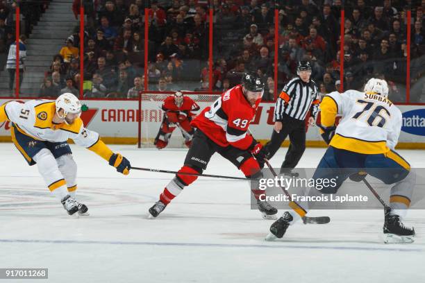 Christopher DiDomenico of the Ottawa Senators controls the puck against Austin Watson and P.K. Subban of the Nashville Predators at Canadian Tire...