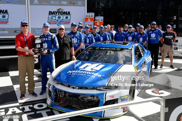 Alex Bowman, driver of the Nationwide Chevrolet, poses with team owner Rick Hendrick, crew chief Greg Ives and crew members after winning the pole...