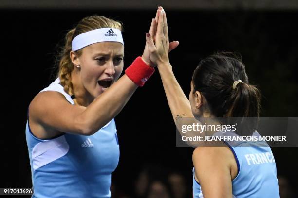 France's Kristina Mladenovic and Amandine Hesse react during their double tennis match against Belgium's Kirsten Flipkens and Elise Mertens during...