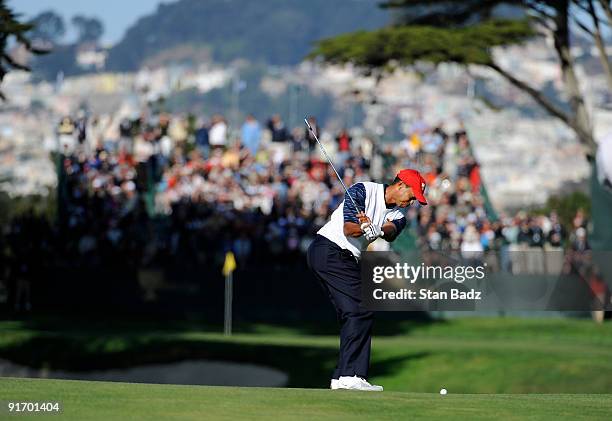 Tiger Woods hits to the 15th green during the second round four-ball matches for The Presidents Cup at Harding Park Golf Club on October 9, 2009 in...