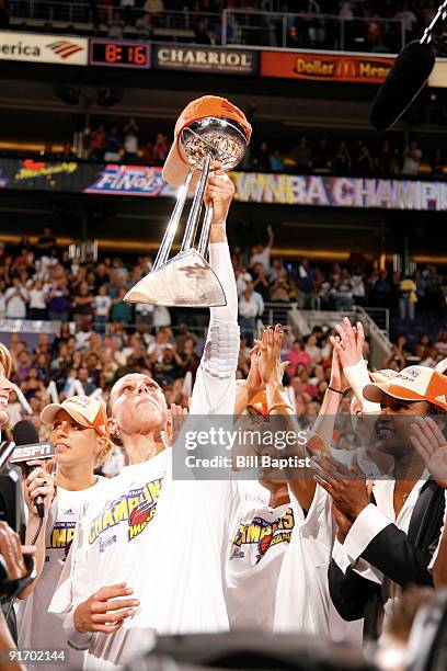 Diana Taurasi of the Phoenix Mercury celebrates with the Trophy after defeating the Indiana Fever during Game Five of the WNBA Finals on October 9,...