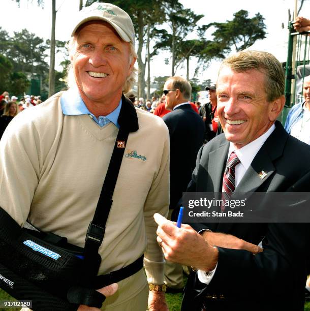 International team captain, Greg Norman, left, and PGA TOUR Commissioner, Tim Finchem, right, seen at the first tee box during the second round...