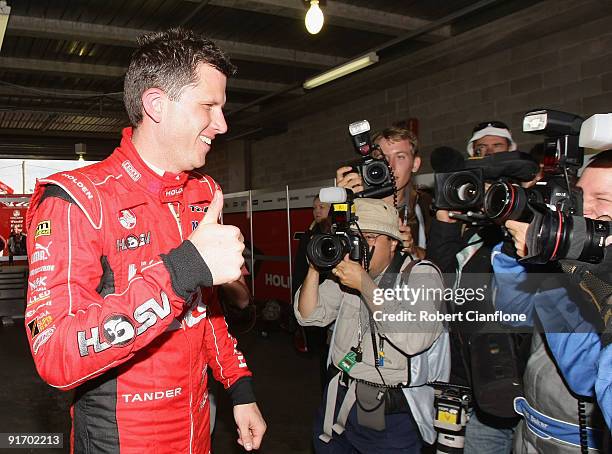 Garth Tander driver of Holden Racing Team Holden celebrates his qualification, with teammate Will Davison for pole position for the Bathurst 1000,...