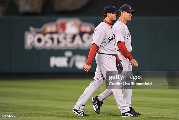 Starting pitcher Josh Beckett of the Boston Red Sox and pitching coach John Farrell walk on to the field to take on the Los Angeles Angels of Anaheim...