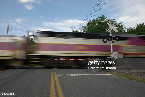 speeding train crossing a street - railway crossing stock pictures, royalty-free photos & images