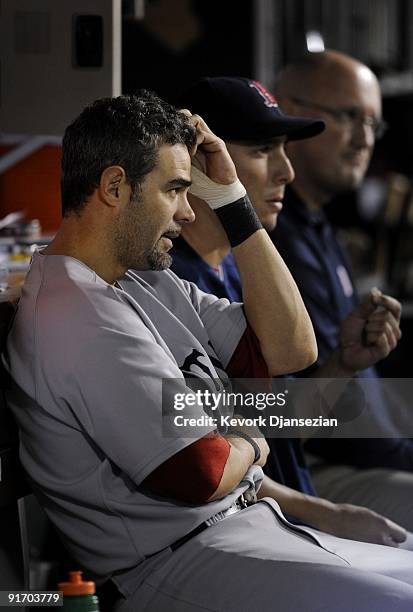 Mike Lowell of the Boston Red Sox watches the game from the dugout during the ALDS in the 2009 MLB Playoffs against the Los Angeles Angels of Anaheim...