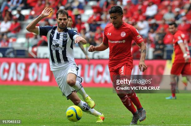 Toluca's Alexis Vega vies for the ball with Monterrey's Jose Basanta during their Mexican Clausura tournament football match at the Nemesio Diez...