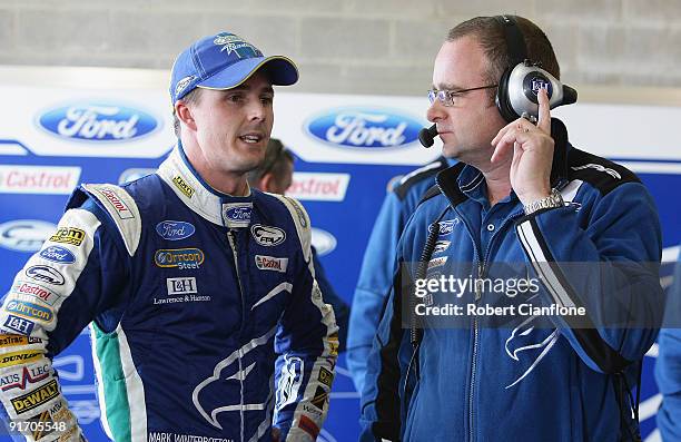 Tim Edwards team principal for Ford Performance Racing talks with driver Mark Winterbottom after his qualifying lap during qualifying for the...