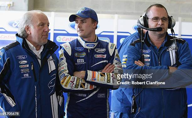 Dave Richards owner of Pro Drive talks with driver Mark Winterbottom and Tim Edwards team principal for Ford Performance Racing during qualifying for...
