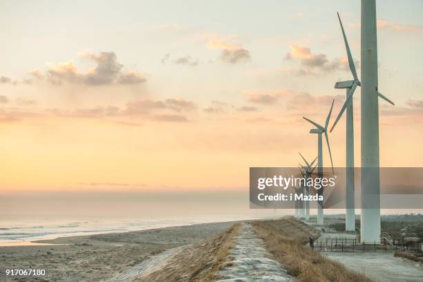 wind power generation and road. - wind power japan stock pictures, royalty-free photos & images