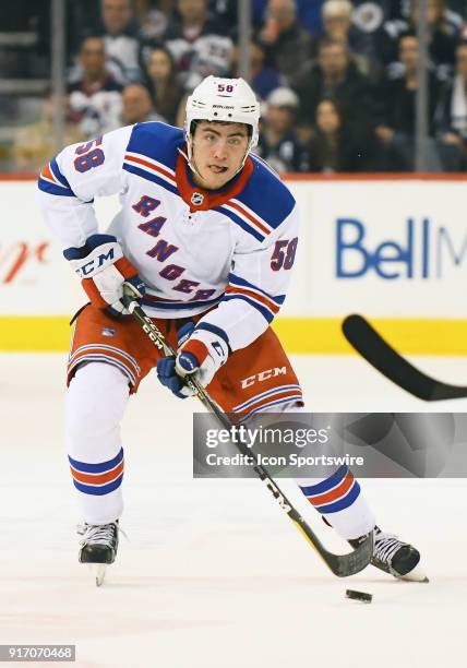 New York Rangers Defenceman John Gilmour skates the puck up ice during a NHL game between the Winnipeg Jets and New York Rangers on February 11, 2018...