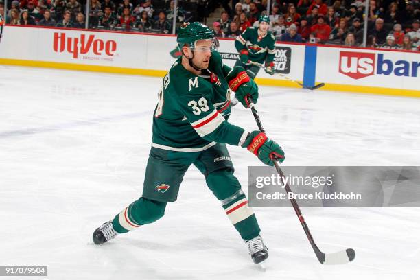 Nate Prosser of the Minnesota Wild dumps the puck against the Vegas Golden Knights during the game at the Xcel Energy Center on February 2, 2018 in...