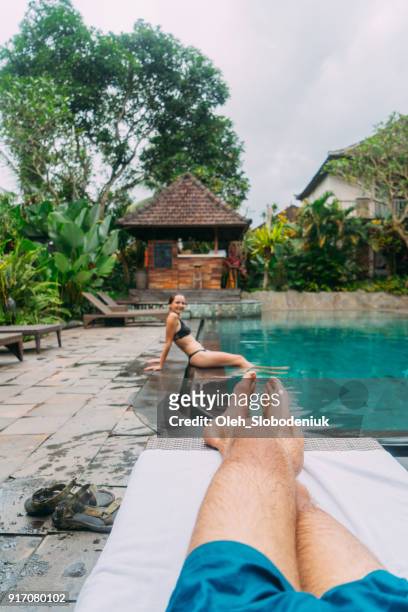 woman near the pool in hotel  in bali - bali spa stock pictures, royalty-free photos & images