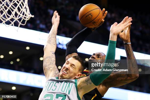 Lebron James of the Cleveland Cavaliers is fouled as he drives to the basket by Daniel Theis of the Boston Celtics during a game at TD Garden on...
